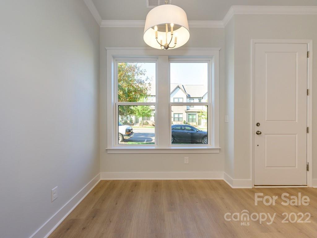 5915 Ardrey Kell Road Charlotte, NC 28105 - Photo 9 of 32 an empty room with wooden floor and windows