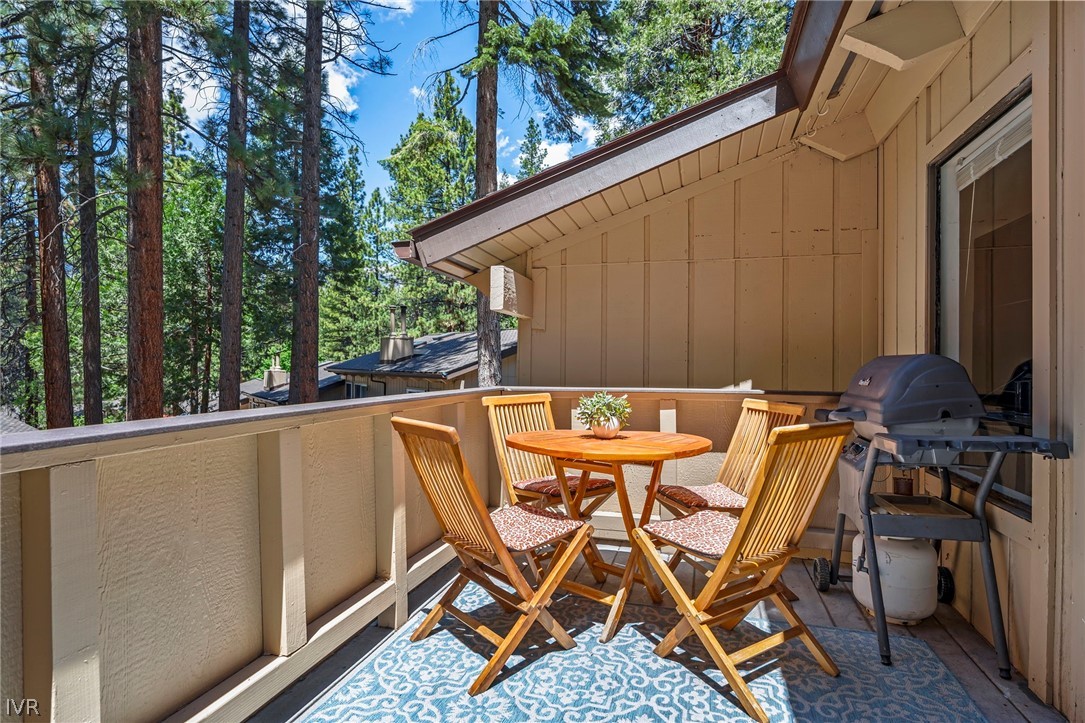 321 Ski Way, Unit 137 Incline Village, NV 89451 - Photo 2 of 21 a view of a patio with table and chairs with wooden floor and fence