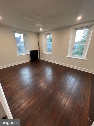 a view of a livingroom with wooden floor and window