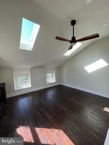 a view of wooden floor and windows in a room