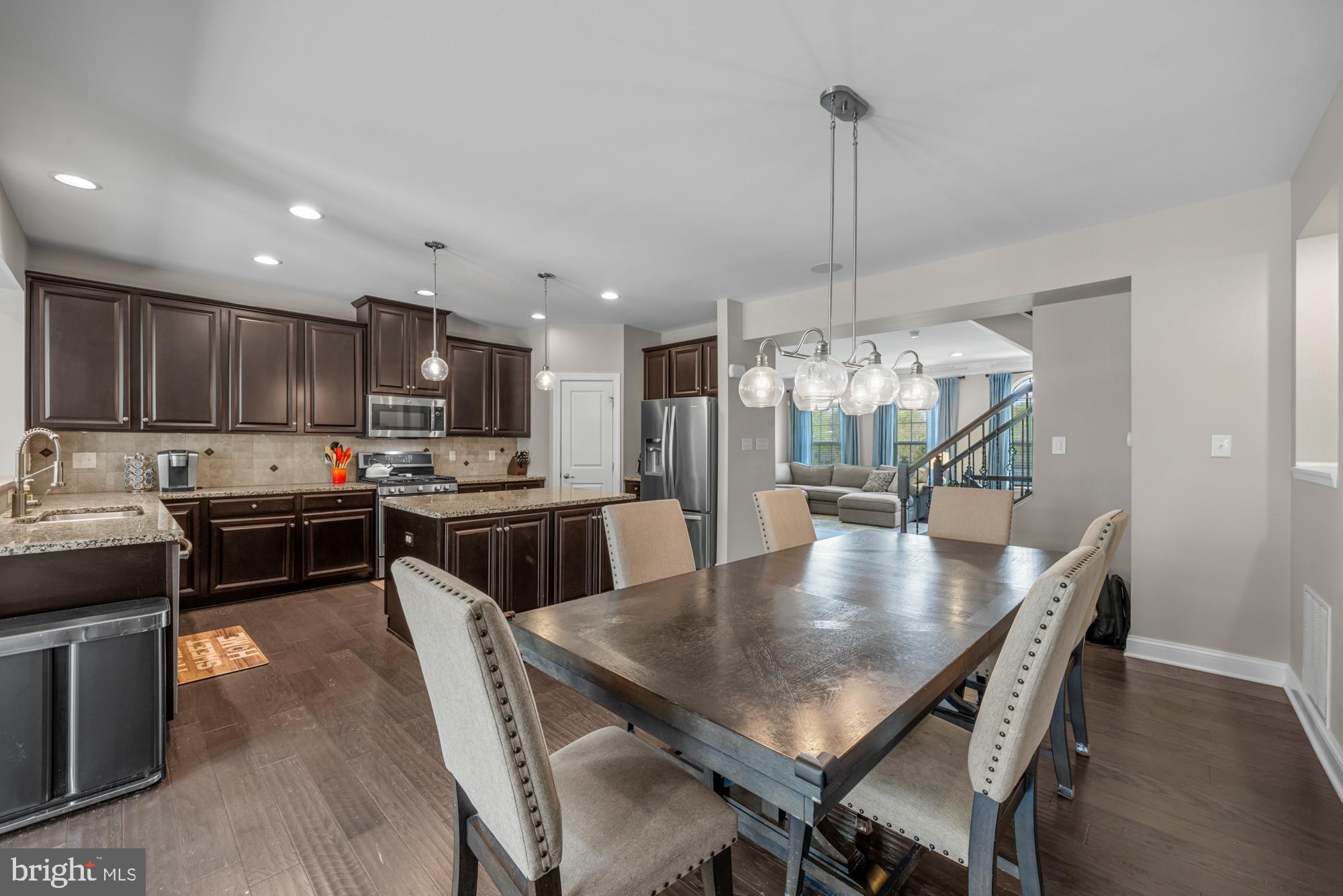 89 Isabelle Court Marlton, NJ 08053 - Photo 12 of 31 a kitchen with a dining table chairs sink and stove
