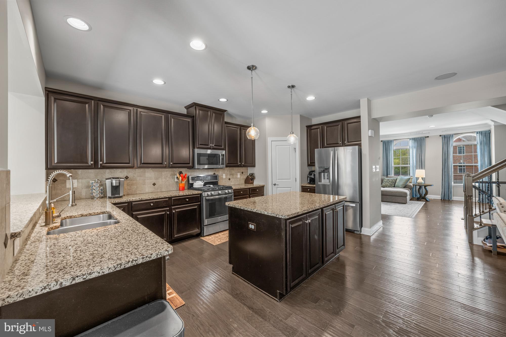 89 Isabelle Court Marlton, NJ 08053 - Photo 5 of 31 a kitchen with stainless steel appliances granite countertop a stove top oven a refrigerator a sink and a dining table with wooden floor