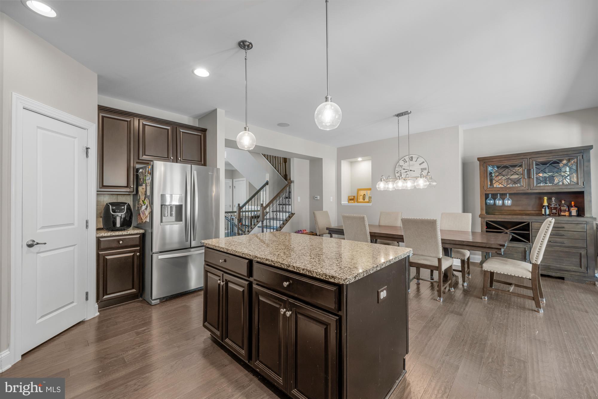 89 Isabelle Court Marlton, NJ 08053 - Photo 8 of 31 a kitchen with stainless steel appliances granite countertop a refrigerator a stove a sink a dining table and chairs with wooden floor