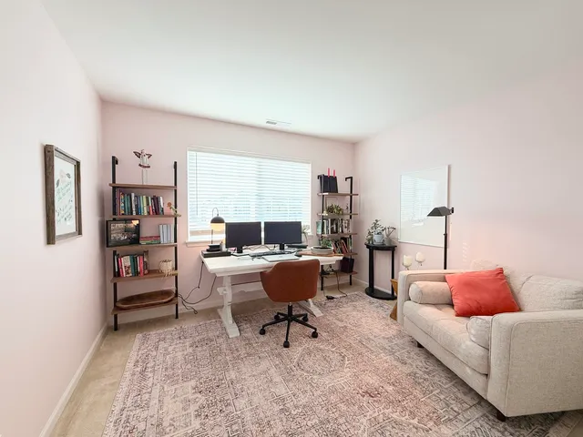 a living room with furniture and a chair