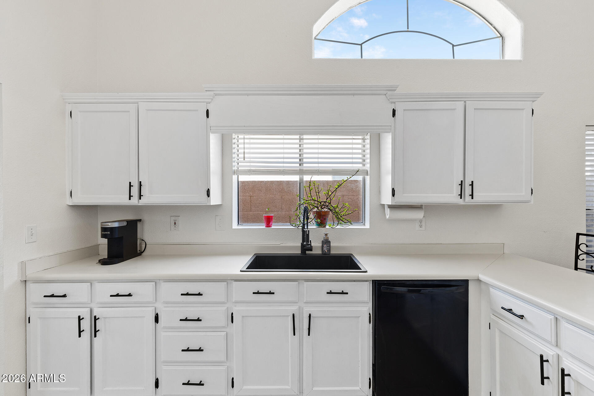 9002 West Coronado Road Phoenix, AZ 85037 - Photo 16 of 54 a kitchen with cabinets appliances and a window