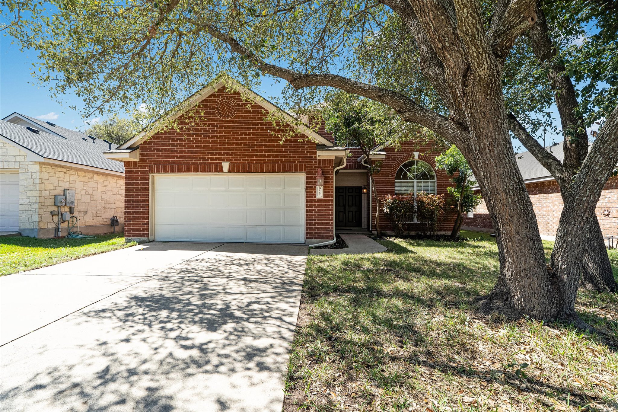 2207 Clover Ridge Drive Cedar Park, TX 78613 - Photo 2 of 21 a backyard of a house with large trees and plants