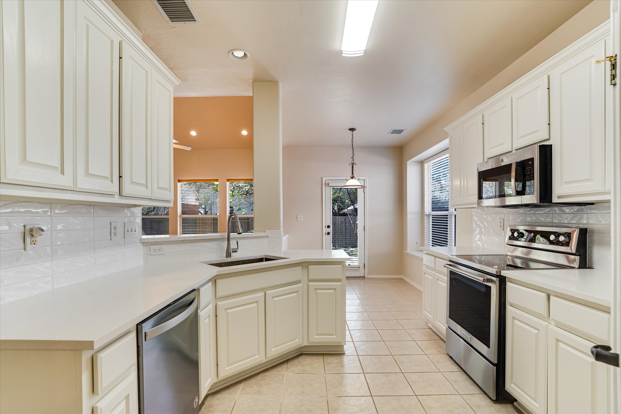 2207 Clover Ridge Drive Cedar Park, TX 78613 - Photo 8 of 21 a kitchen with stainless steel appliances granite countertop a sink and a stove