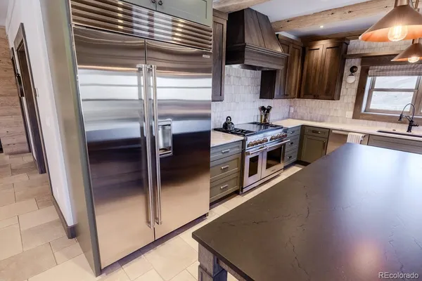 a kitchen with stainless steel appliances a stove and a refrigerator