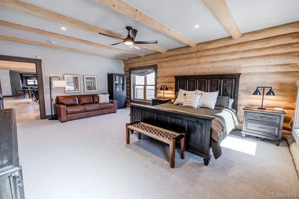 a bedroom with a bed and ceiling fan