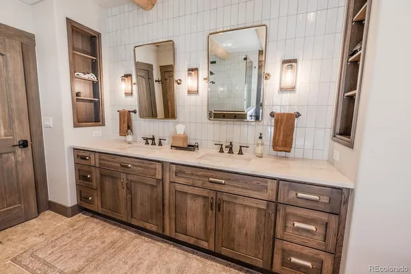 a spacious bathroom with a double vanity sink and a mirror