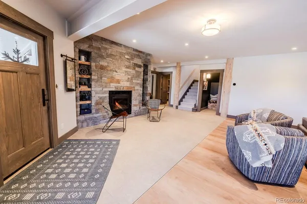 a living room with furniture and a wooden floor