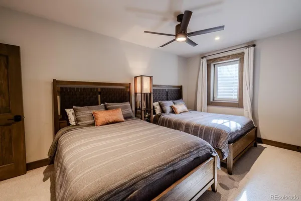 a bedroom with two beds and a large window