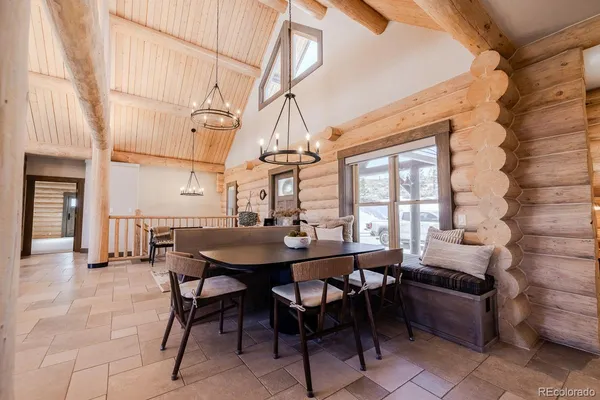 a view of a dining room with furniture and chandelier