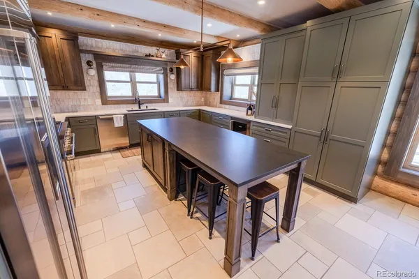 a kitchen with stainless steel appliances granite countertop a sink counter space and a window