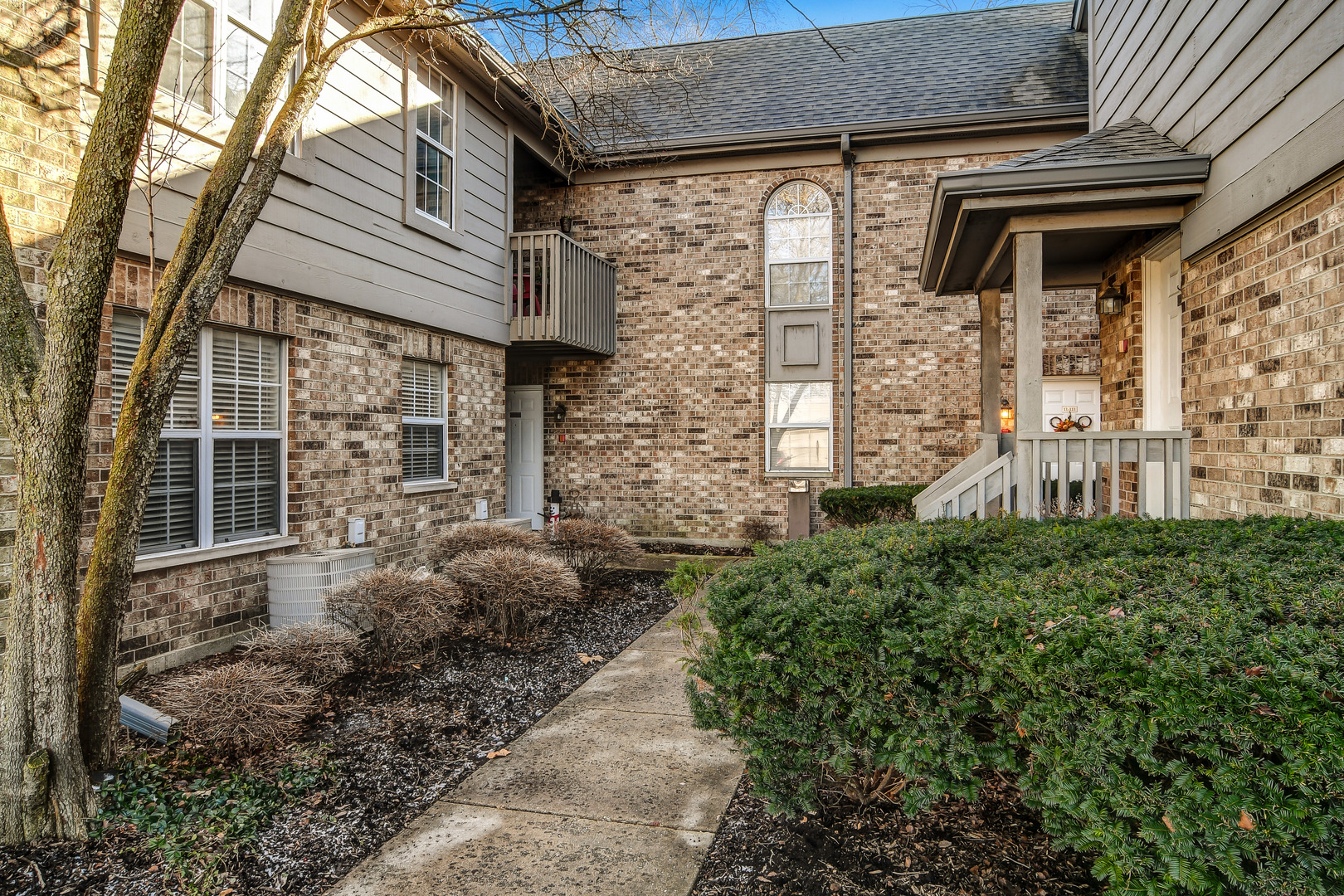 11 Foxcroft Road, Unit 219 Naperville, IL 60565 - Photo 1 of 16 a front view of a house with garden