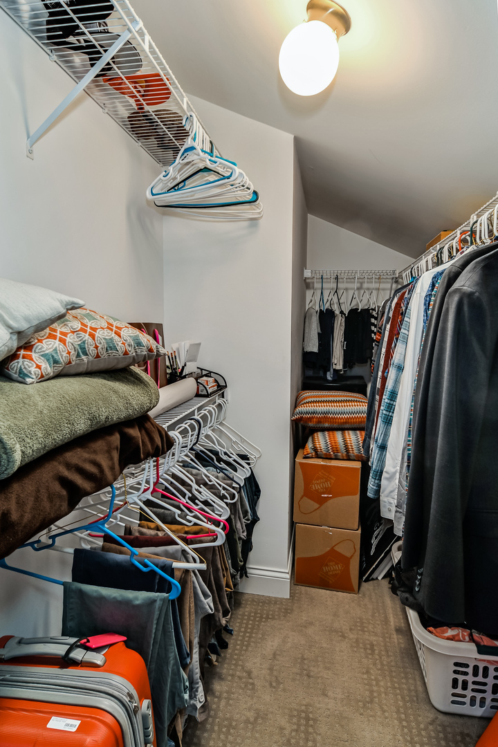 11 Foxcroft Road, Unit 219 Naperville, IL 60565 - Photo 11 of 16 a view of walk in closet with clothes and shoes