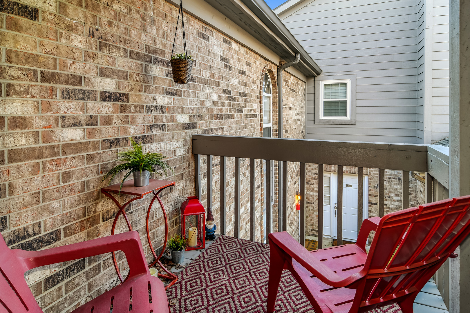 11 Foxcroft Road, Unit 219 Naperville, IL 60565 - Photo 13 of 16 a view of a balcony with two chairs and a potted plant