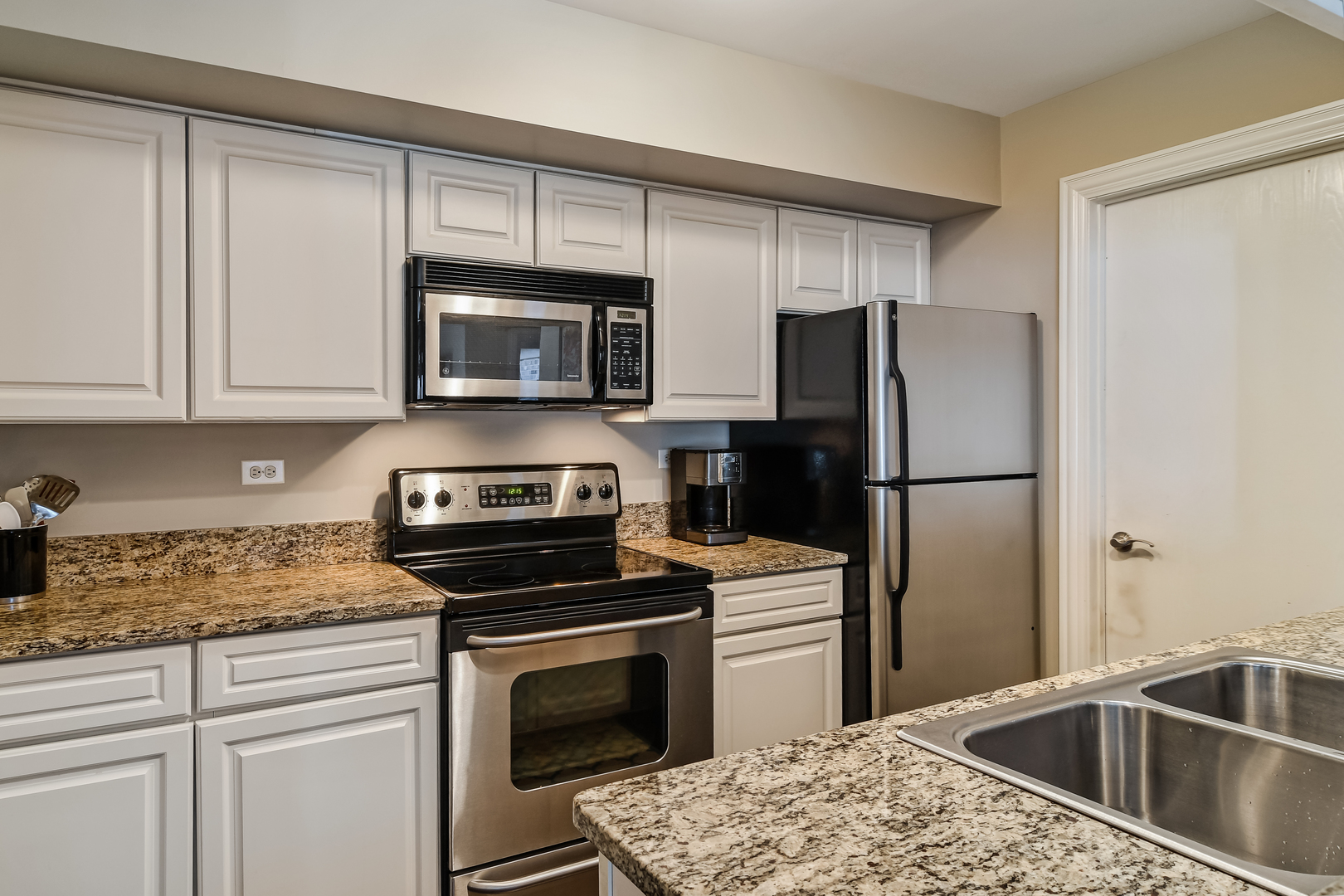 11 Foxcroft Road, Unit 219 Naperville, IL 60565 - Photo 7 of 16 a kitchen with a refrigerator sink and microwave