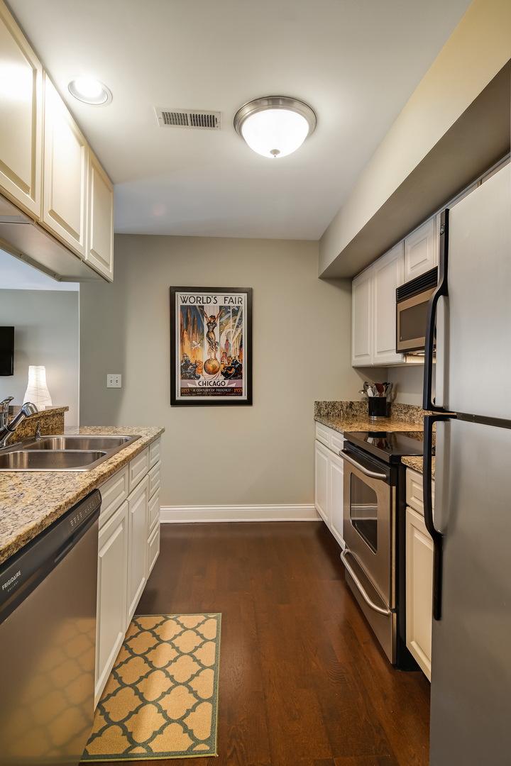 11 Foxcroft Road, Unit 219 Naperville, IL 60565 - Photo 8 of 16 a kitchen with stainless steel appliances granite countertop a refrigerator and a stove top oven
