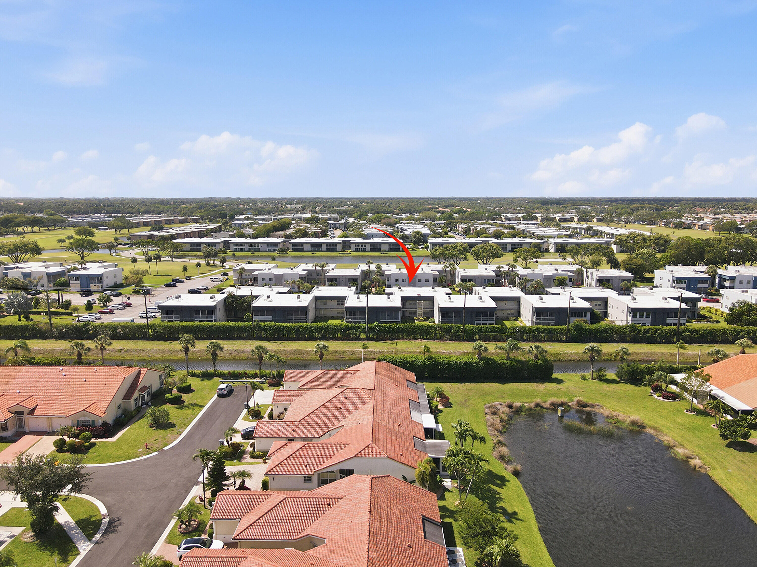 226 Normandy Lane, Unit E Delray Beach, FL 33484 - Photo 1 of 35 a view of a lake with a city