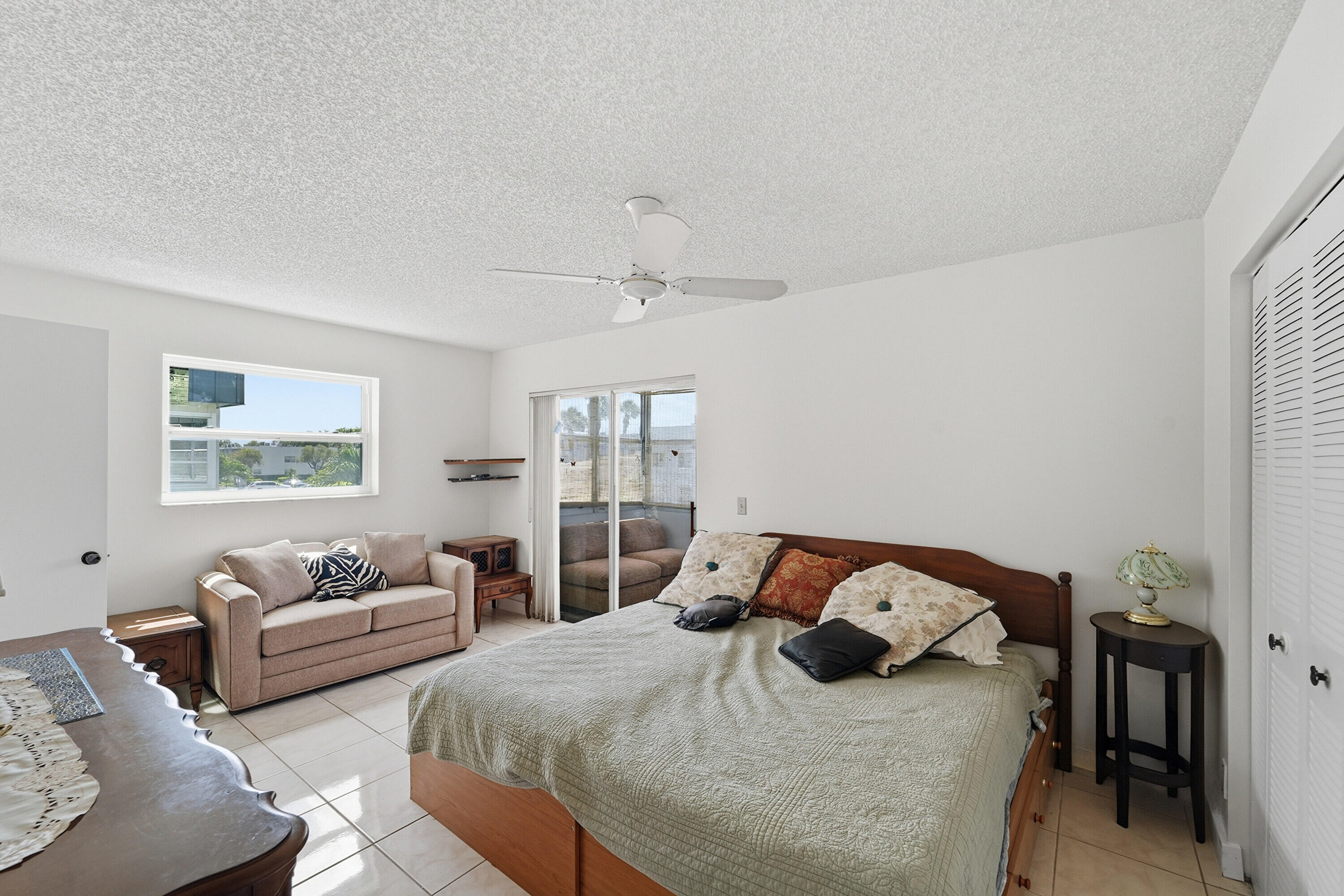226 Normandy Lane, Unit E Delray Beach, FL 33484 - Photo 11 of 35 a bedroom with bed and a couch