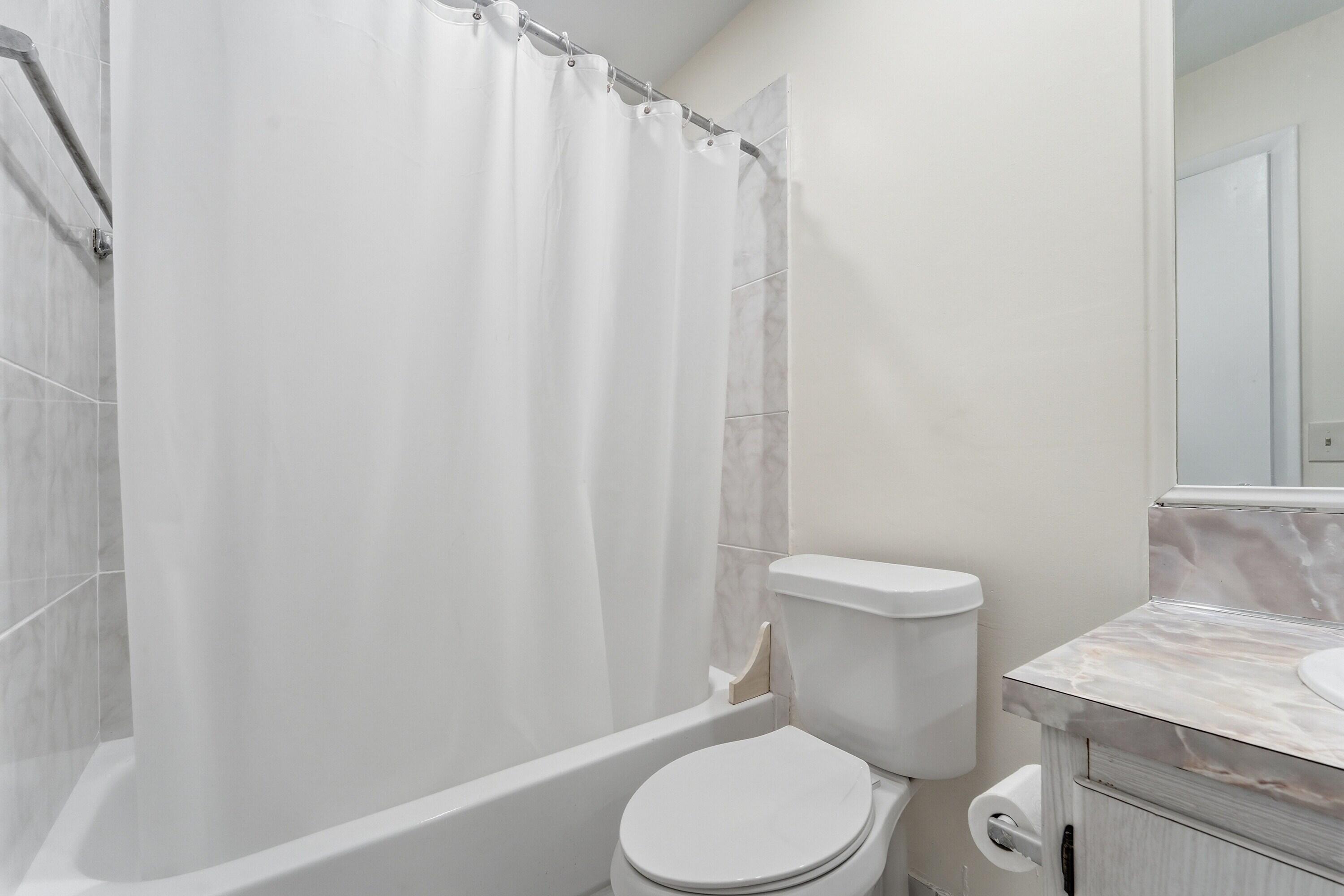 226 Normandy Lane, Unit E Delray Beach, FL 33484 - Photo 12 of 35 a white toilet sitting next to a white sink
