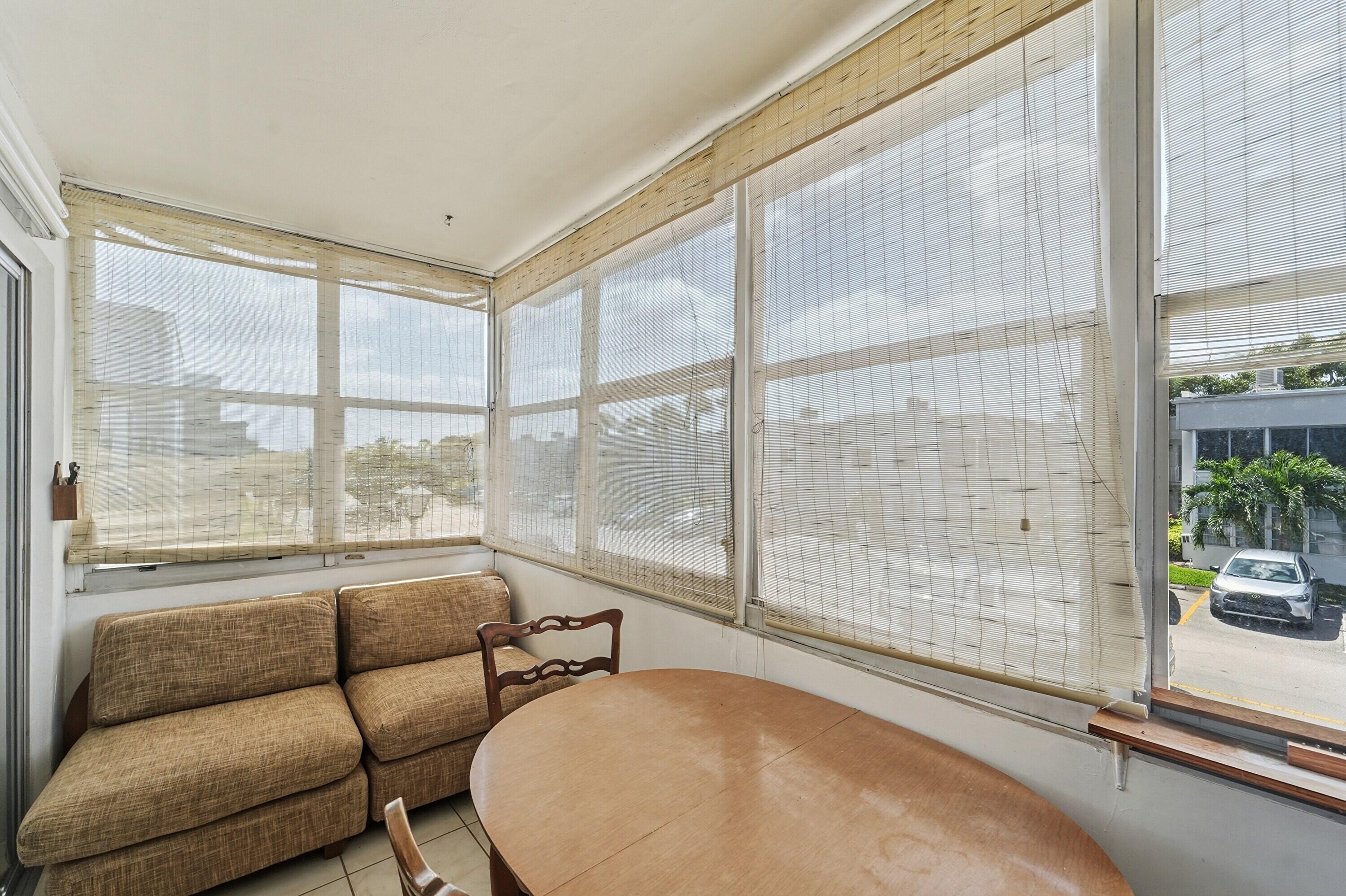 226 Normandy Lane, Unit E Delray Beach, FL 33484 - Photo 14 of 35 a living room with furniture and a large window with outer view
