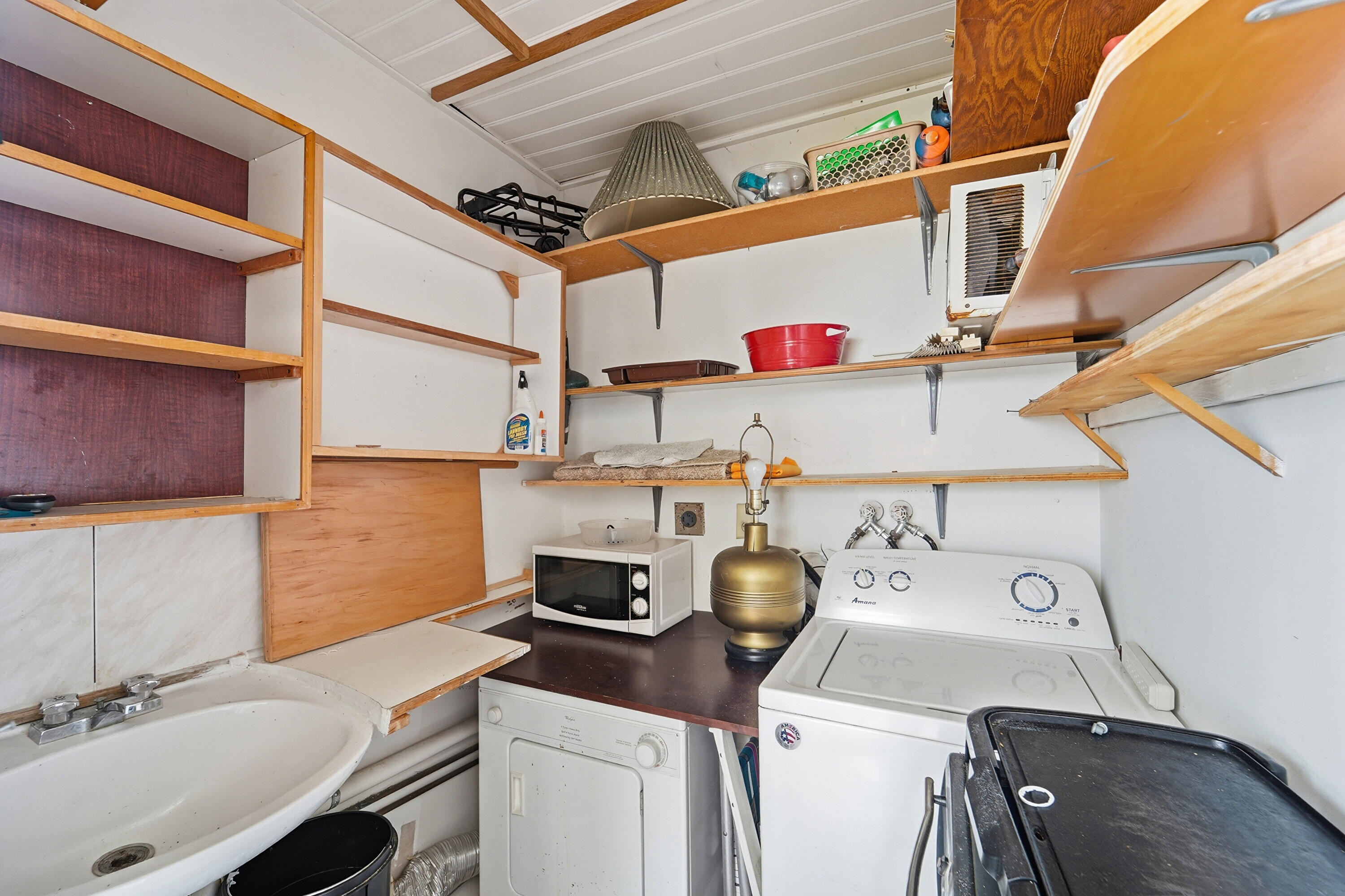 226 Normandy Lane, Unit E Delray Beach, FL 33484 - Photo 15 of 35 a utility room with a sink a washer and dryer