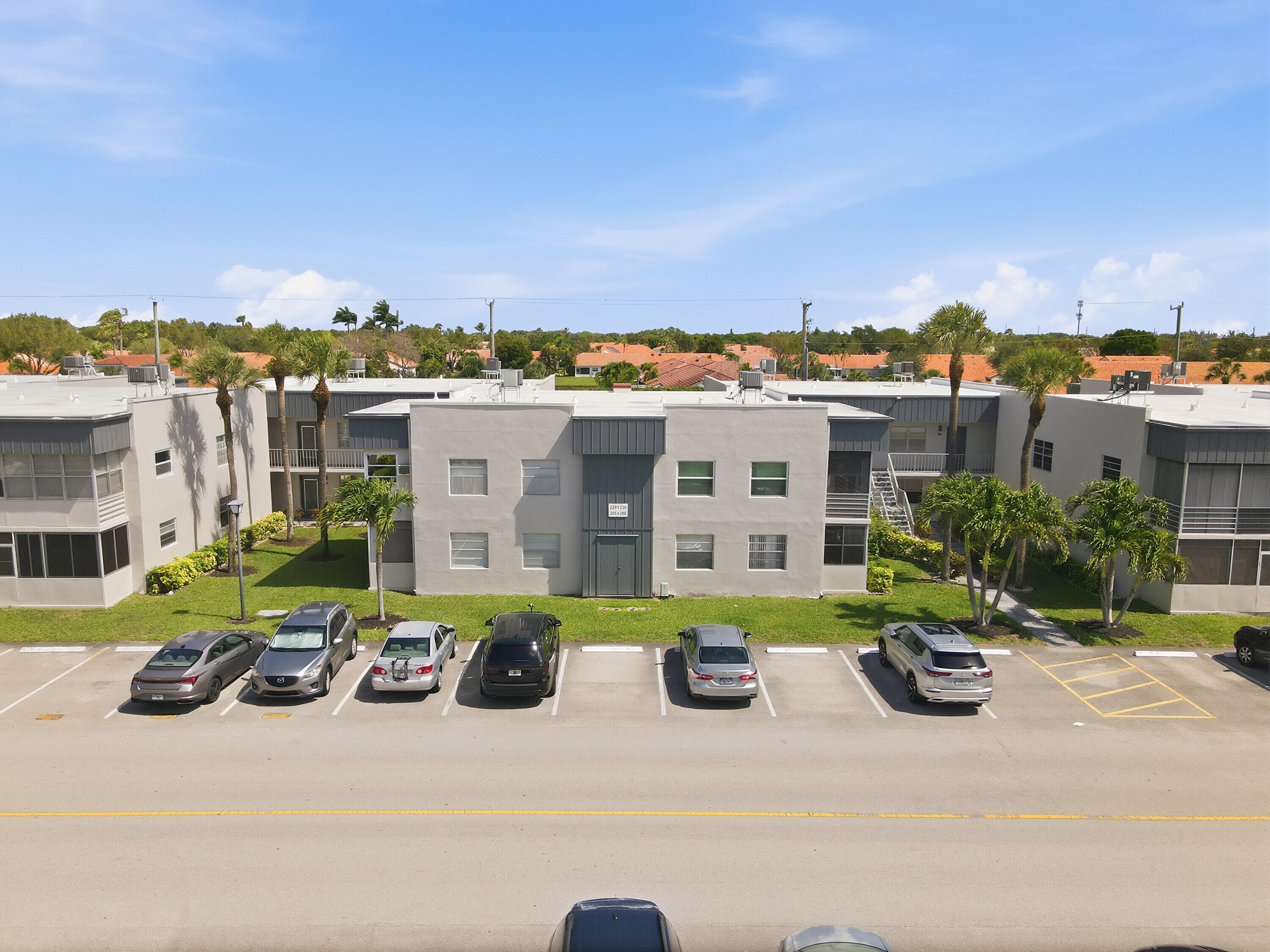 226 Normandy Lane, Unit E Delray Beach, FL 33484 - Photo 20 of 35 a view of multiple houses with a yard