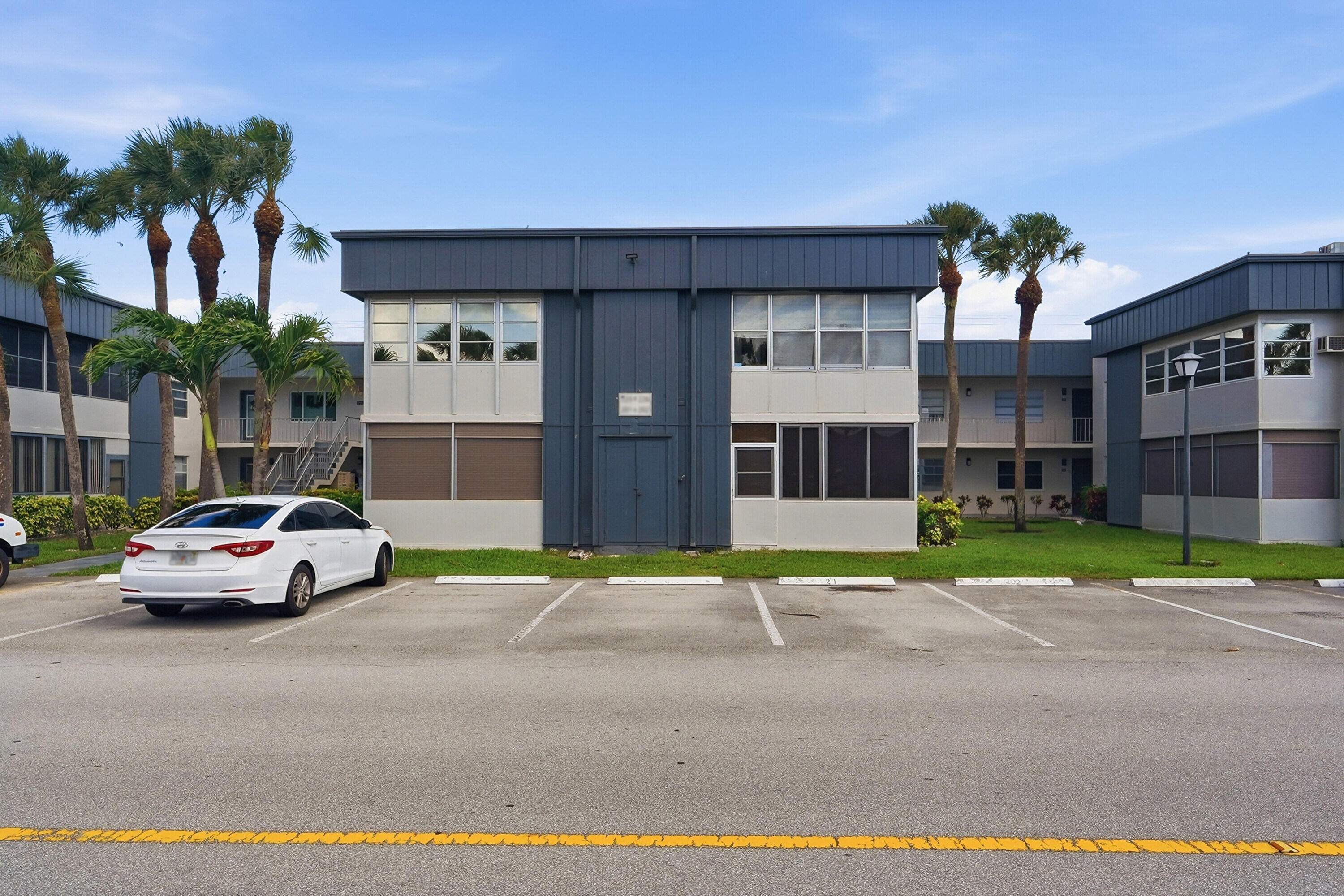 226 Normandy Lane, Unit E Delray Beach, FL 33484 - Photo 21 of 35 a car parked in front of a building