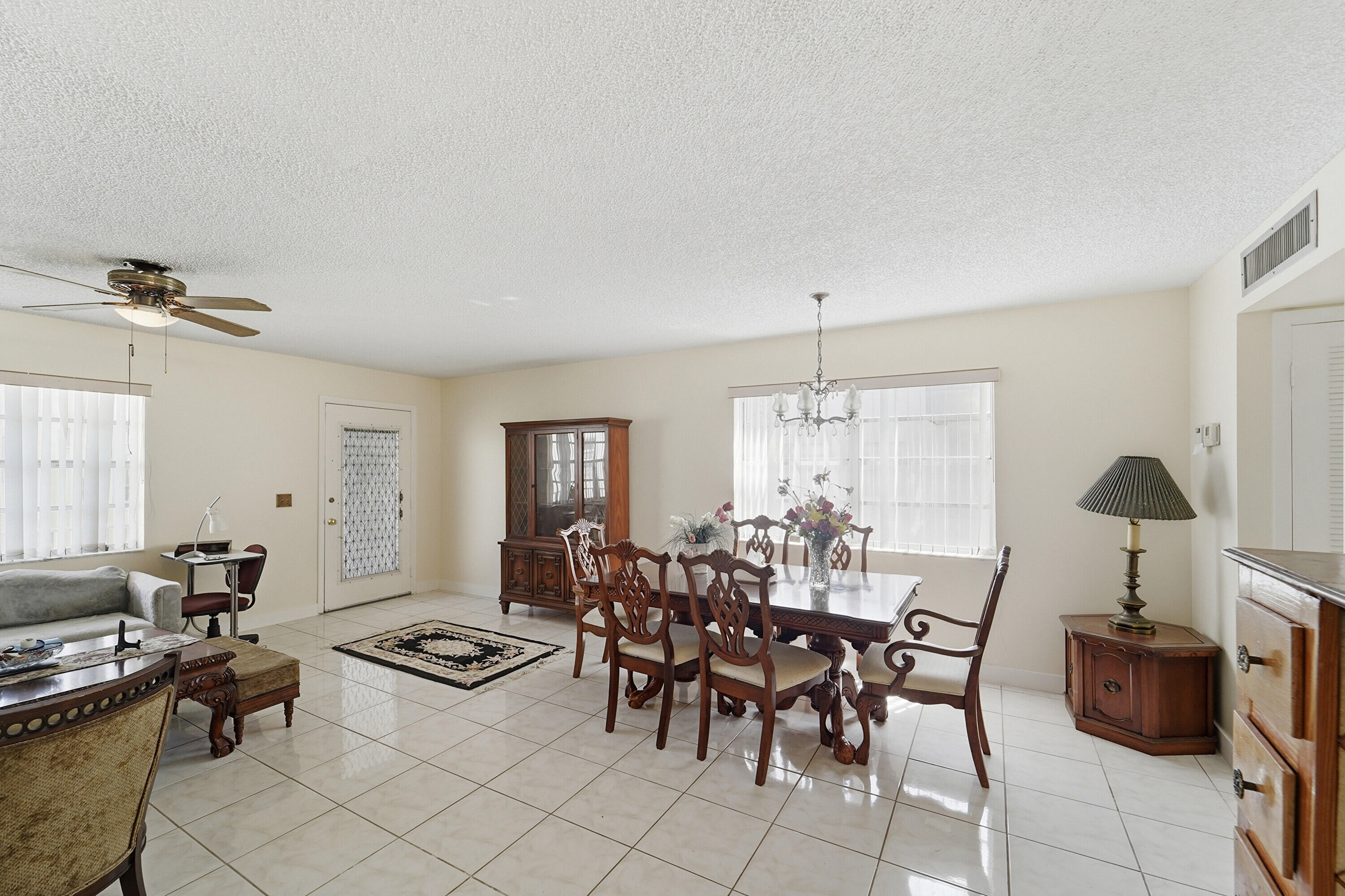 226 Normandy Lane, Unit E Delray Beach, FL 33484 - Photo 5 of 35 a view of a a dining room with furniture window and outside view