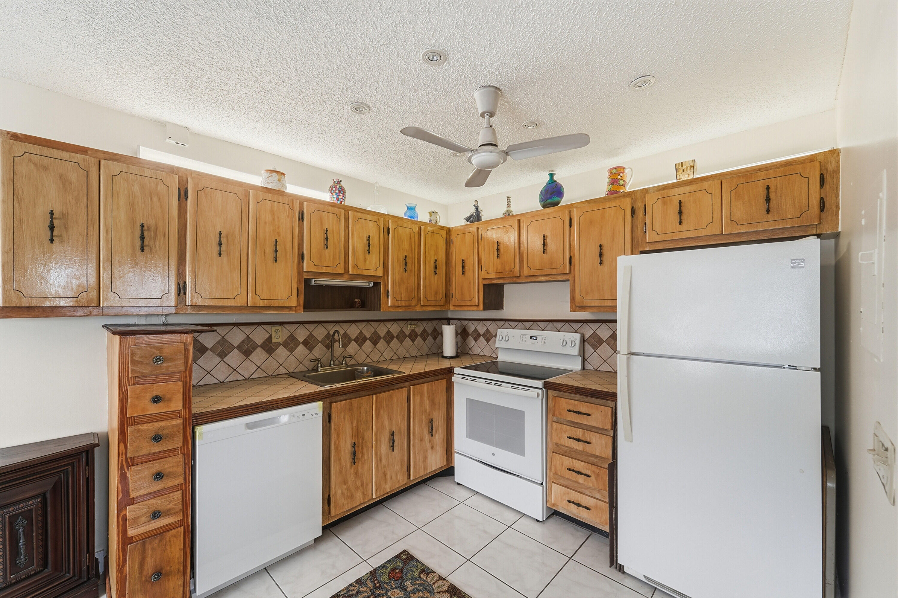 226 Normandy Lane, Unit E Delray Beach, FL 33484 - Photo 7 of 35 a kitchen with cabinets stainless steel appliances and a counter top space