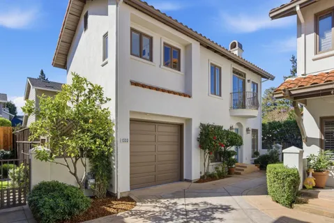 a front view of a house with a garden