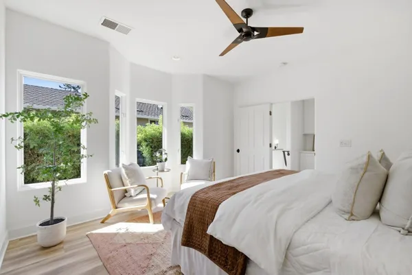 a bedroom with bed and windows