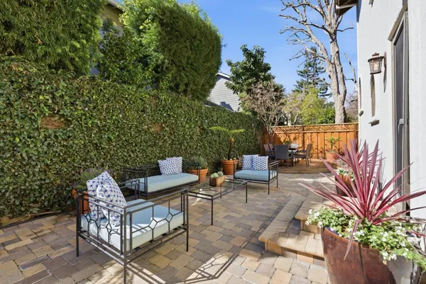 a view of backyard with seating area and green space