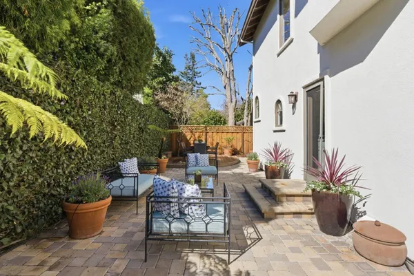 a view of a patio with couple of potted plants