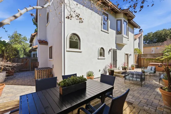 an outdoor space with patio couch and potted plants