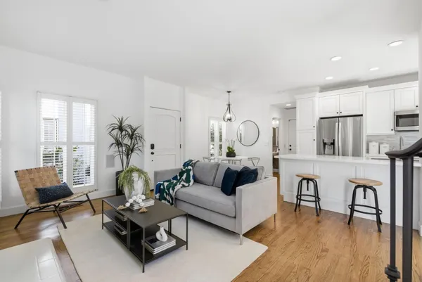 a living room with furniture a wooden floor and a table