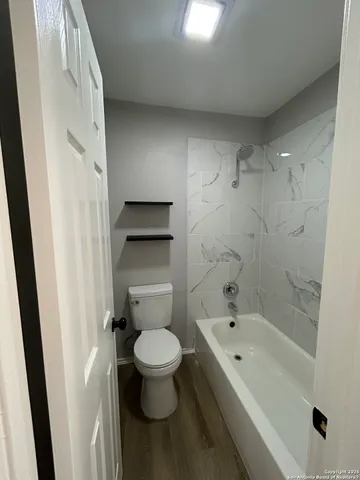 a bathroom with a toilet and a bathtub