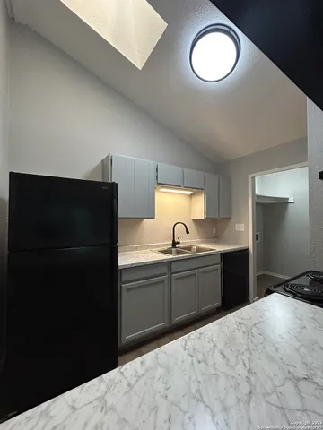 a kitchen with a refrigerator and a sink