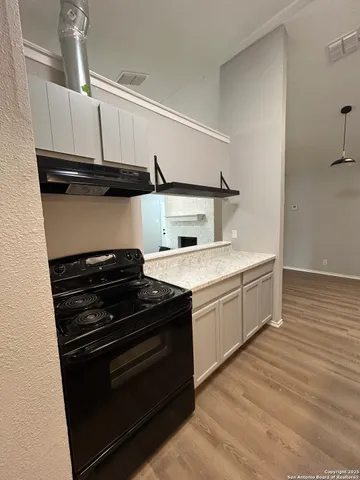a kitchen with a stove and a microwave