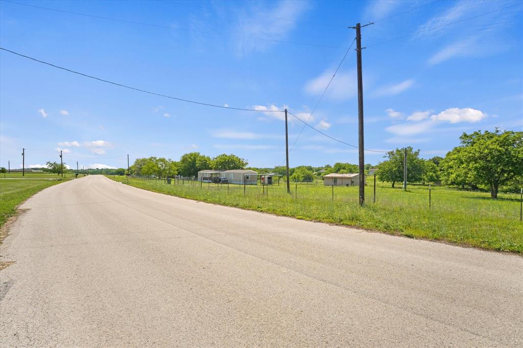 Tbd Branding Iron Road Rhome, TX 76078 - Photo 7 of 7 a view of a road with a big yard and palm trees