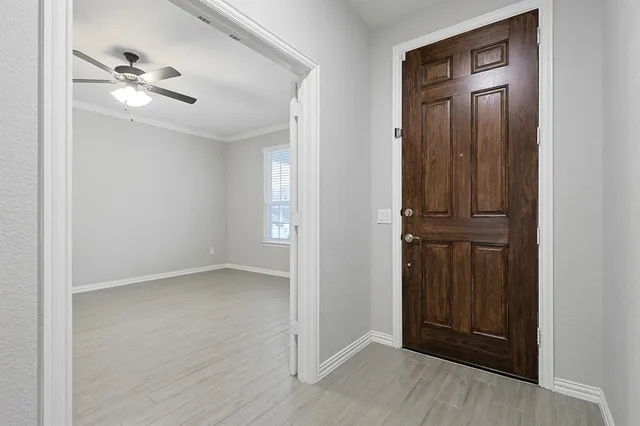 a view of hallway with wooden floor