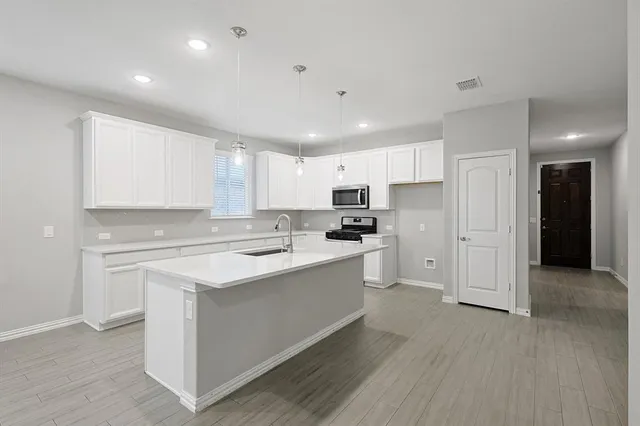 a kitchen with a sink faucet and refrigerator
