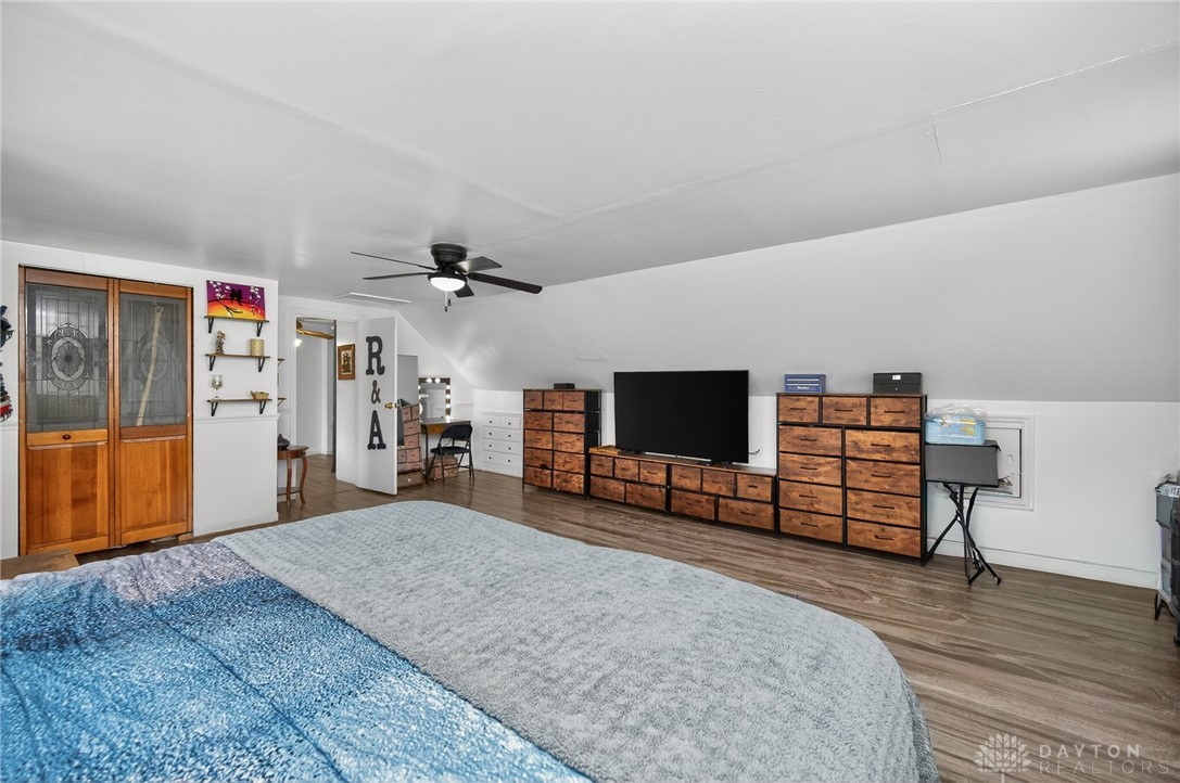 3301 Wildwood Road Middletown, OH 45042 - Photo 38 of 68 This spacious bedroom features warm wood flooring and a classic ceiling fan, perfect for comfortable living.