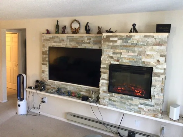 a bathroom with granite countertop a sink and a fireplace