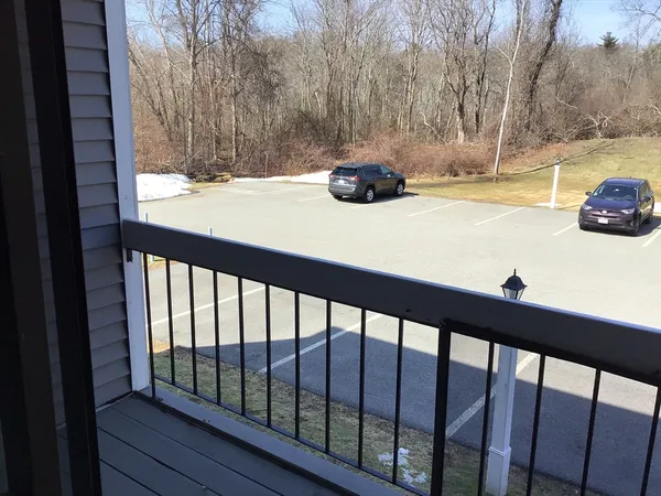 a view of a balcony with yard