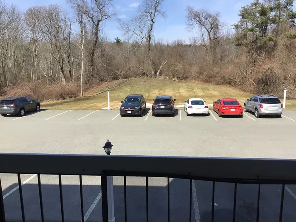 a view of a street with cars parked