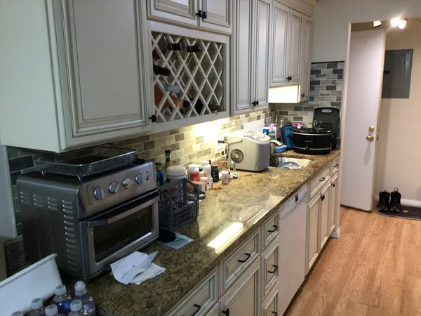 a kitchen with stainless steel appliances granite countertop a stove a sink and a microwave