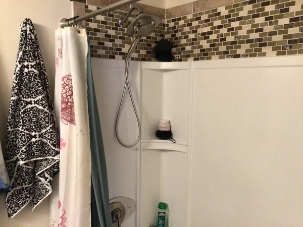 a bed sitting in a bedroom next to a window and a wooden floor